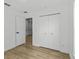 The bedroom features light wood floors, a closet for storage, and access to the ensuite bathroom at 274 W 20Th St, Apopka, FL 32703