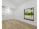 Bright, empty bedroom featuring new flooring and a window with backyard views at 274 W 20Th St, Apopka, FL 32703