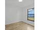 Simple bedroom featuring a large window that provides natural light and backyard views at 274 W 20Th St, Apopka, FL 32703