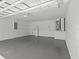 The large garage is unfinished with painted walls, a smooth painted floor, and open ceiling at 274 W 20Th St, Apopka, FL 32703