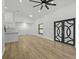 Open-concept living space with contemporary flooring, sleek lighting, and elegant doors to the backyard at 274 W 20Th St, Apopka, FL 32703