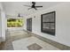Spacious screened porch with tile flooring, fan, and views of the yard at 274 W 20Th St, Apopka, FL 32703