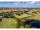 Scenic aerial shot featuring the golf course, community homes, and a serene pond with lush greenery at 3008 Pinnacle Ct, Clermont, FL 34711