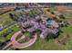 Stunning aerial view of the clubhouse, pool, and surrounding amenities including tennis courts and baseball field at 3008 Pinnacle Ct, Clermont, FL 34711