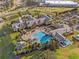 Expansive aerial view showcasing the pool, clubhouse, and lush landscaping creating a resort-style community at 3008 Pinnacle Ct, Clermont, FL 34711