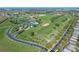 Overhead shot of a community featuring a golf course, clubhouse, pool, and meticulously landscaped surroundings at 3008 Pinnacle Ct, Clermont, FL 34711