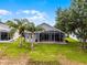 Aerial view of the backyard with a screened-in patio and lawn at 3008 Pinnacle Ct, Clermont, FL 34711