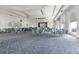 A ballroom with tables, chairs, a stage, and a chandelier, perfect for events and gatherings at 3008 Pinnacle Ct, Clermont, FL 34711