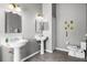 Bathroom with pedestal sinks, unique light fixtures, and tile flooring creating a cozy and functional space at 3008 Pinnacle Ct, Clermont, FL 34711