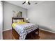 This bedroom has a ceiling fan, side table with lamp, and laminate wood flooring at 3008 Pinnacle Ct, Clermont, FL 34711