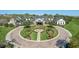 Stunning clubhouse entrance with circular driveway, manicured landscaping, and elegant architectural details at 3008 Pinnacle Ct, Clermont, FL 34711