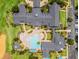 Aerial view of a community clubhouse featuring a uniquely shaped pool, sun loungers, and meticulously landscaped grounds at 3008 Pinnacle Ct, Clermont, FL 34711
