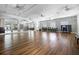 A large, airy community room with a mirrored wall, hardwood floors, and natural light at 3008 Pinnacle Ct, Clermont, FL 34711