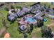 Aerial view showcasing an opulent clubhouse with a swimming pool, gazebo, and palm tree-lined walkways at 3008 Pinnacle Ct, Clermont, FL 34711