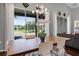 Dining area featuring a modern chandelier, views of the golf course, and access to the outdoor living space at 3008 Pinnacle Ct, Clermont, FL 34711