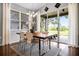Bright dining area with a modern light fixture and a view of the lanai and golf course at 3008 Pinnacle Ct, Clermont, FL 34711