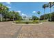 Beautiful entrance leading to the clubhouse with a central fountain and brick-paved roundabout at 3008 Pinnacle Ct, Clermont, FL 34711