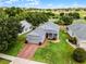 Charming home featuring a brick driveway, manicured lawn, and a golf course view, perfect for relaxed living at 3008 Pinnacle Ct, Clermont, FL 34711