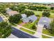 Well-manicured lawn and mature trees surrounding this single-story home in a quiet neighborhood, with golf course view at 3008 Pinnacle Ct, Clermont, FL 34711