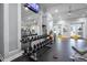 The community fitness center is equipped with weights and cardio equipment, mirrored walls, and exterior doors at 3008 Pinnacle Ct, Clermont, FL 34711