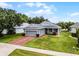 Charming single-Gathering home featuring a two-car garage, manicured lawn, and lush landscaping at 3008 Pinnacle Ct, Clermont, FL 34711