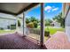 Covered front porch offering a scenic view of the manicured front yard, lush greenery, and neighborhood, creating a peaceful retreat at 3008 Pinnacle Ct, Clermont, FL 34711