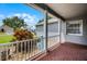 Charming front porch with brick flooring, white railings, and a view of the landscaped yard, perfect for relaxing outdoors at 3008 Pinnacle Ct, Clermont, FL 34711