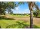 Scenic view of the golf course from the backyard with irrigation sprinklers at 3008 Pinnacle Ct, Clermont, FL 34711