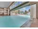 Gorgeous indoor pool with waterfall feature and clear views of the outdoor amenities beyond at 3008 Pinnacle Ct, Clermont, FL 34711