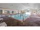 Bright indoor community pool featuring brick flooring, ample seating, and large windows at 3008 Pinnacle Ct, Clermont, FL 34711