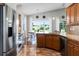 Beautiful kitchen featuring stainless steel appliances, granite countertops, and a breakfast bar overlooking the dining area at 3008 Pinnacle Ct, Clermont, FL 34711