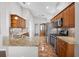 Spacious kitchen with granite countertops, stainless steel appliances, and tile flooring at 3008 Pinnacle Ct, Clermont, FL 34711