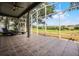 Enjoy outdoor living on this screened-in lanai with tile flooring and stunning views of lush greenery and a golf course at 3008 Pinnacle Ct, Clermont, FL 34711
