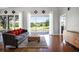 Bright living room featuring hardwood floors, comfortable seating, and a scenic view of the golf course at 3008 Pinnacle Ct, Clermont, FL 34711