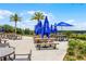 Outdoor picnic seating under blue umbrellas, offering views of the surrounding landscape at 3008 Pinnacle Ct, Clermont, FL 34711