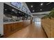 Clean, modern restaurant interior with a service counter, wood floors, and indoor plants at 3008 Pinnacle Ct, Clermont, FL 34711