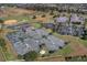 Aerial view showcasing the community's well-maintained tennis courts with nearby parking and clubhouse amenities at 3008 Pinnacle Ct, Clermont, FL 34711