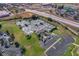 Aerial view of multiple tennis courts with lush greenery and parking available in a well-maintained community at 3008 Pinnacle Ct, Clermont, FL 34711