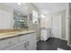 Dual sink bathroom with granite countertops, tiled floors, and a glass-enclosed shower at 308 Michael Blake Blvd, Winter Springs, FL 32708