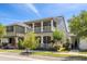 Gray two-story home with double porch, white railing, and well-maintained landscaping at 308 Michael Blake Blvd, Winter Springs, FL 32708
