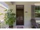 Inviting front porch with a solid wood door, house number, and a welcoming plant at 308 Michael Blake Blvd, Winter Springs, FL 32708