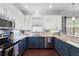 Updated kitchen with white cabinets, granite countertops, and stainless steel appliances at 308 Michael Blake Blvd, Winter Springs, FL 32708