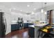 Stylish kitchen with two-toned cabinets, stainless steel appliances, and bar stool seating at 308 Michael Blake Blvd, Winter Springs, FL 32708