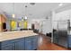 Open-concept living space featuring a kitchen island, stainless steel appliances, and an open layout at 308 Michael Blake Blvd, Winter Springs, FL 32708