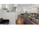 Open-concept living room with a modern staircase, hardwood floors, and a view of the kitchen at 308 Michael Blake Blvd, Winter Springs, FL 32708