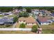 Aerial view of backyard with white fence, shed and view of the community at 310 Cornwallis Ct, Kissimmee, FL 34758