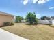 Large backyard featuring a well maintained white fence for privacy, and a neat lawn at 310 Cornwallis Ct, Kissimmee, FL 34758