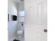 Clean white bathroom with a window for natural light and a towel rack for convenience at 310 Cornwallis Ct, Kissimmee, FL 34758