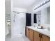 Bathroom with a double vanity, walk-in shower and sleek fixtures at 310 Cornwallis Ct, Kissimmee, FL 34758