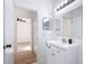 Bathroom with a white vanity and open doorway to a bedroom at 310 Cornwallis Ct, Kissimmee, FL 34758